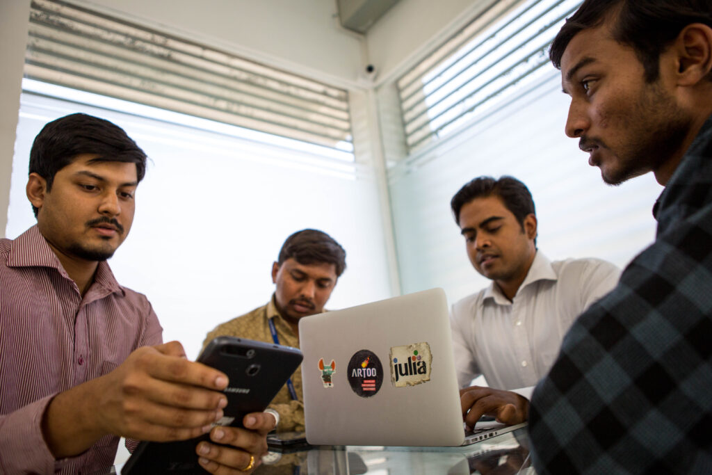 Fintech employees around a computer