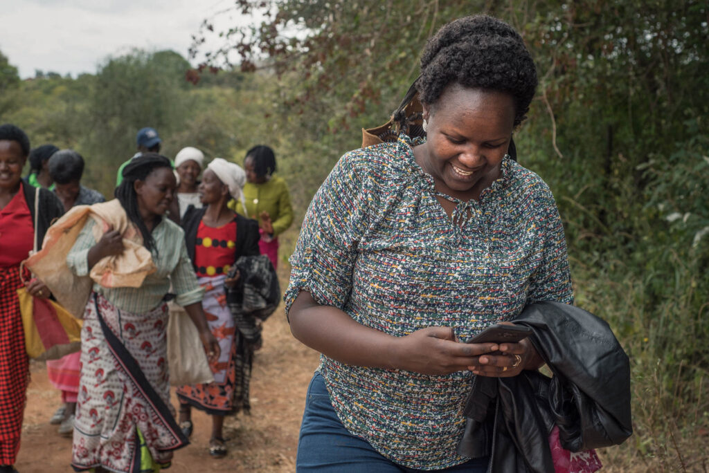 Farmer checks her phone while walking