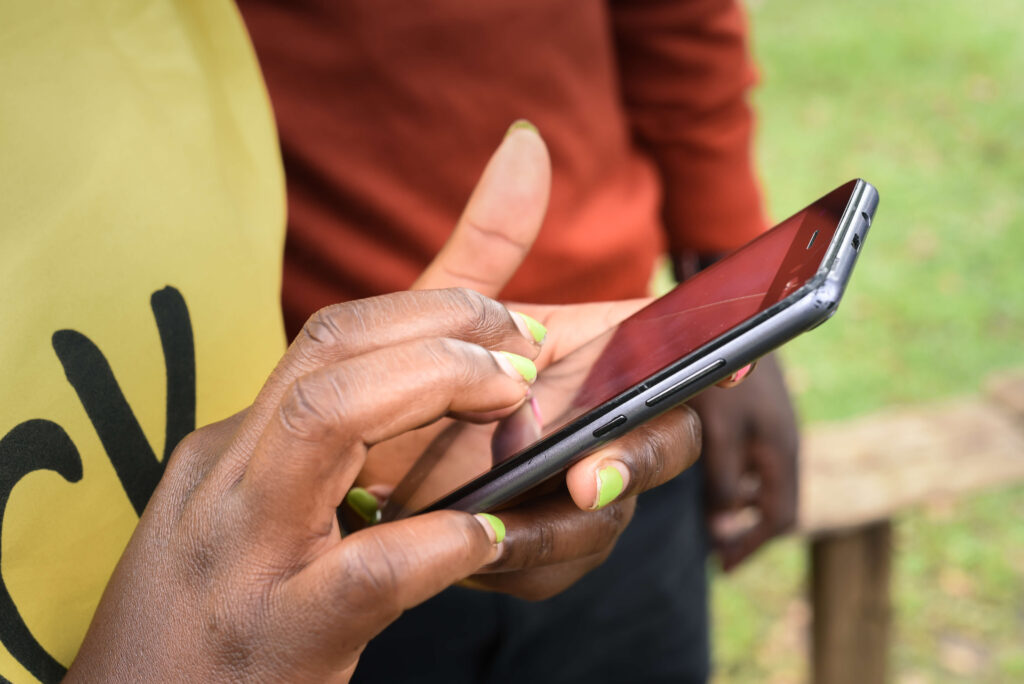 Close-up of person using a mobile phone outside