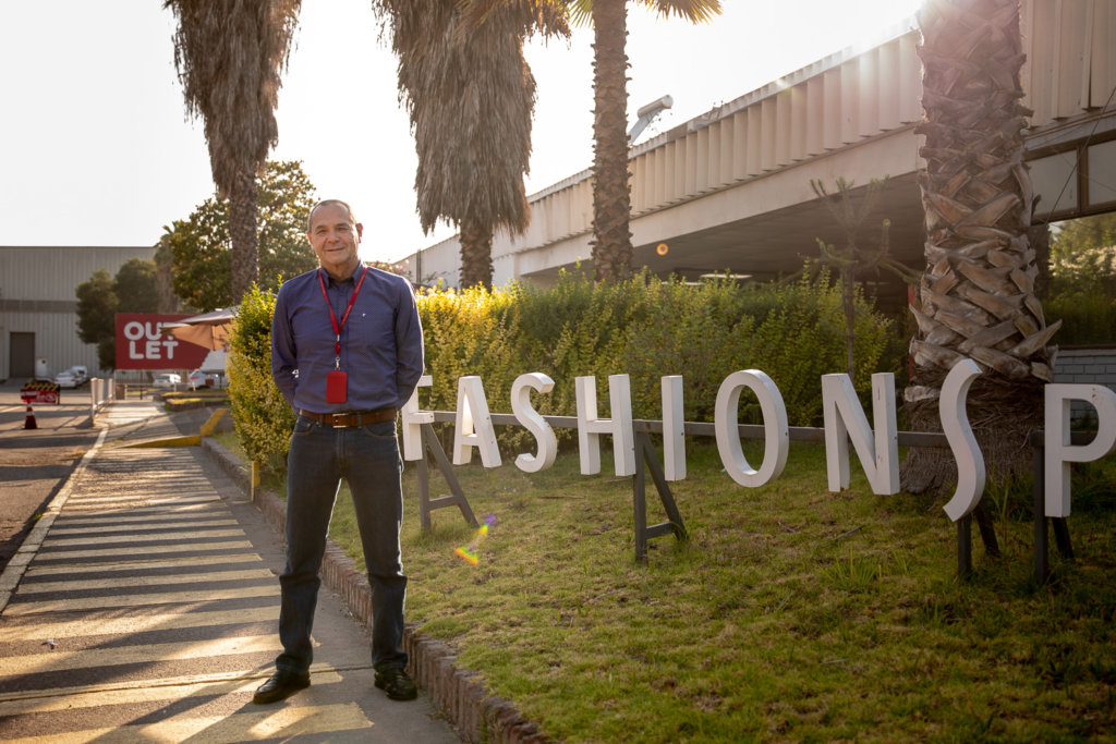Fernando Rocchi outside in front of the Fashions Park sign
