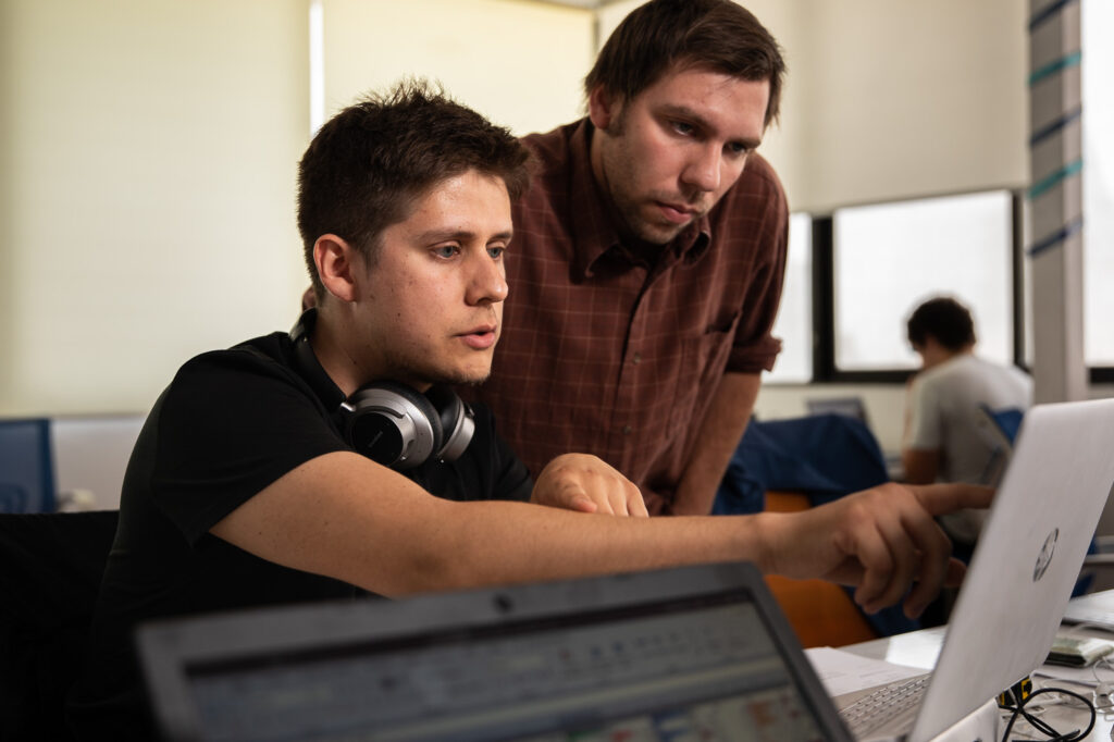 José points to computer screen, showing coworker data