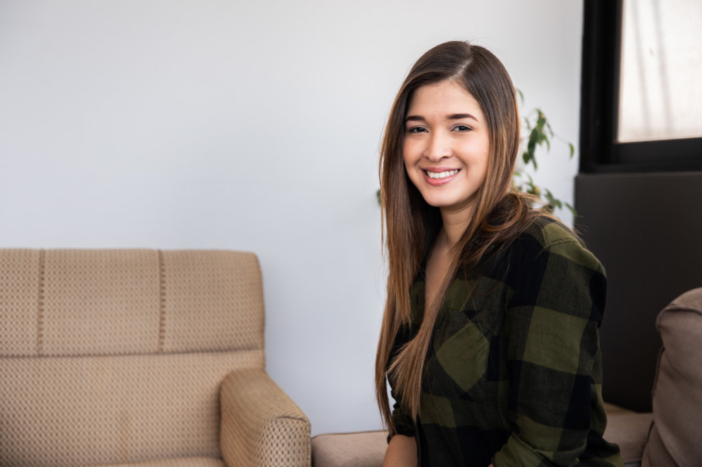 Camila smiles at the camera in the Destacame office