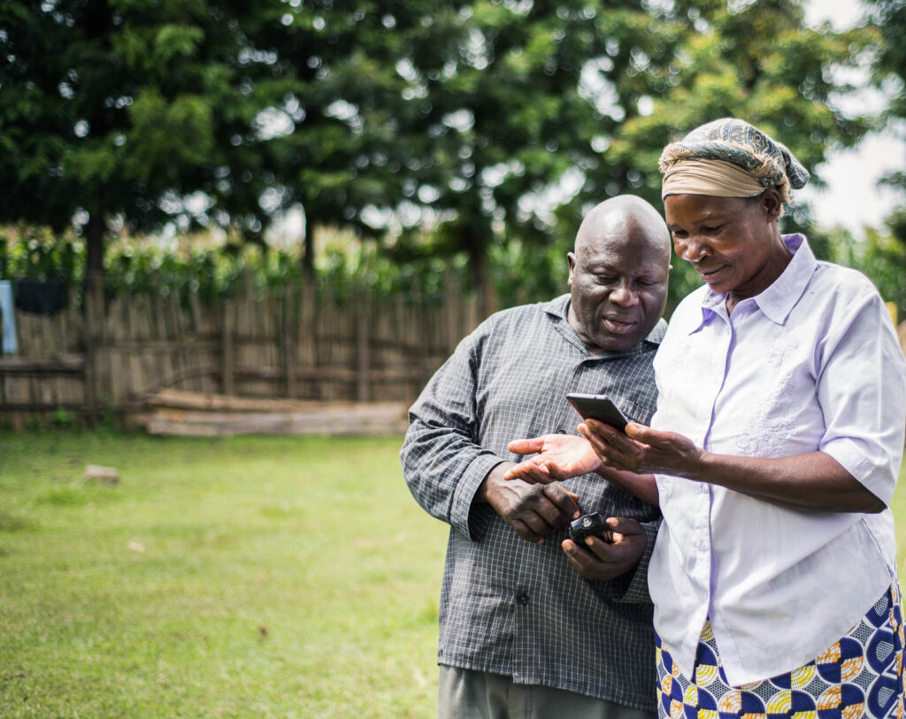 Alfred and Margaret use a mobile phone to access Apollo's services