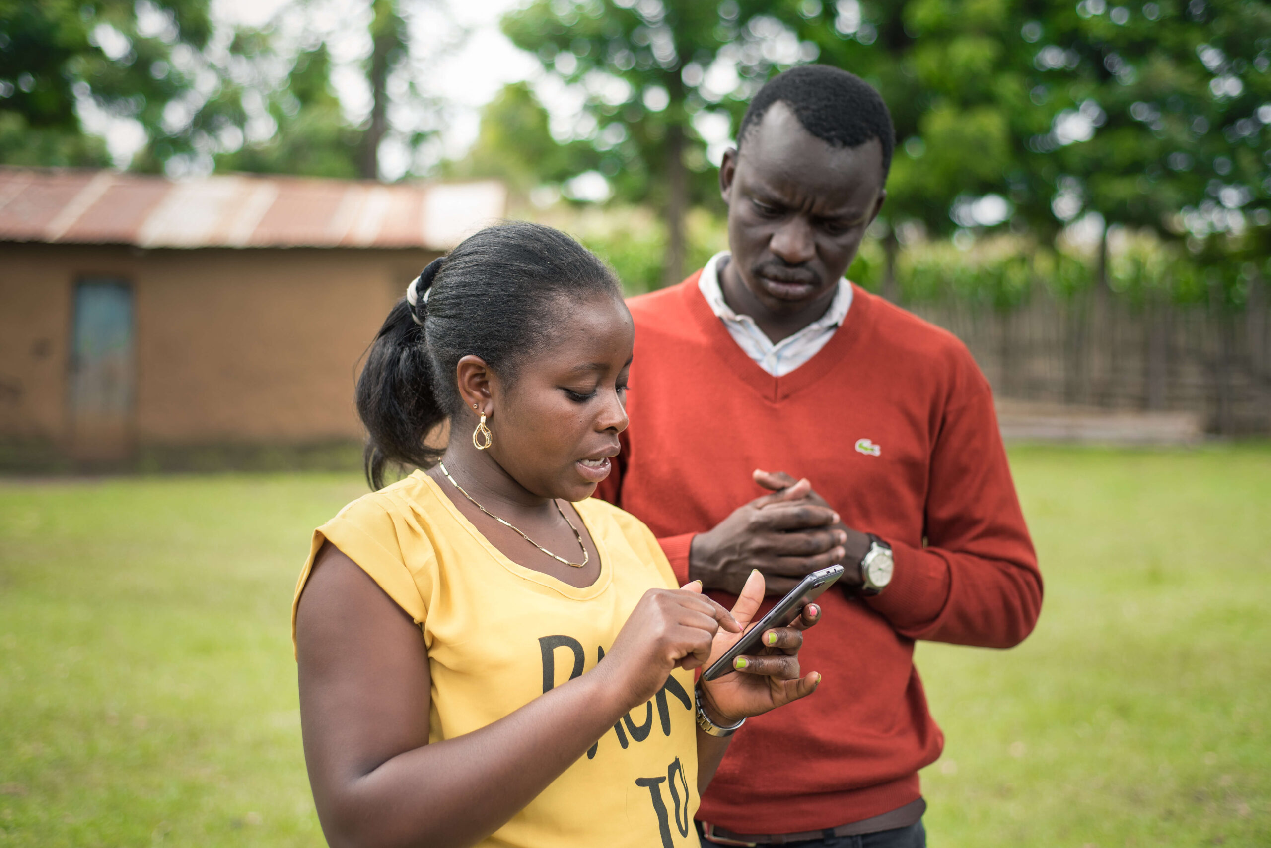 Apollo Agriculture field associate Rebecca setting up an account with a farmer client