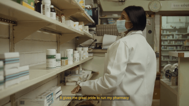A woman pharmacist looks at empty shelves in her pharmacy. The caption reads, "It gives me great pride to run my pharmacy."