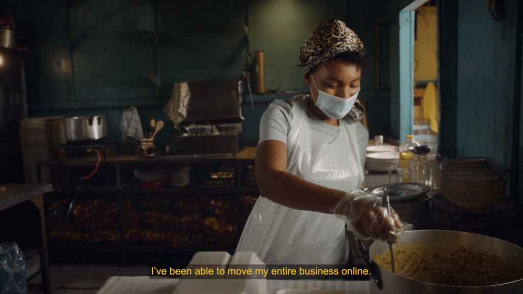 Woman in mask is cooking in the back of a restaurant with a mask on, caption reads "I've been able to move my entire business online"