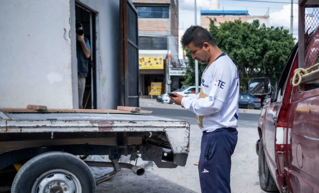 Jose stands next to the truck