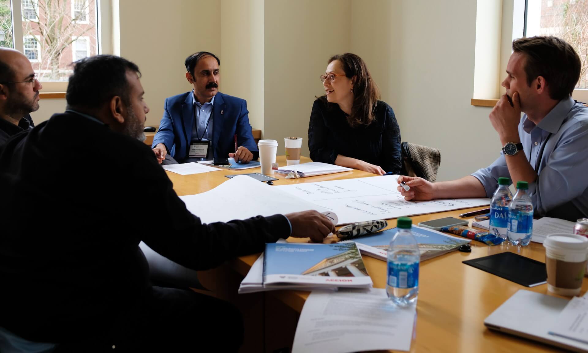 Managing Director of the Center for Financial Inclusion Mayada El-Zoghbi speaks with other participants of the HBS-Accion program.