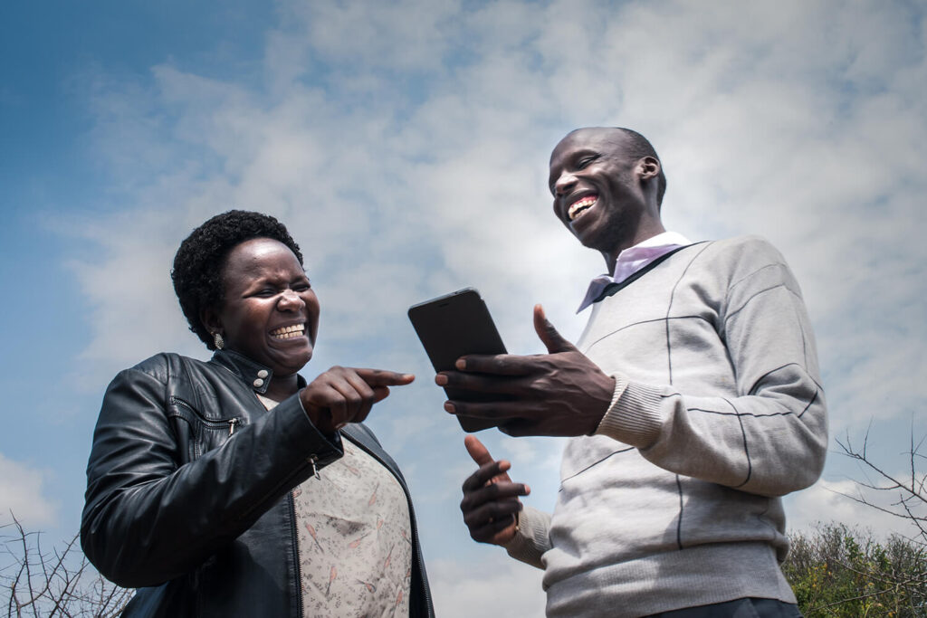 Two people look at a cell phone