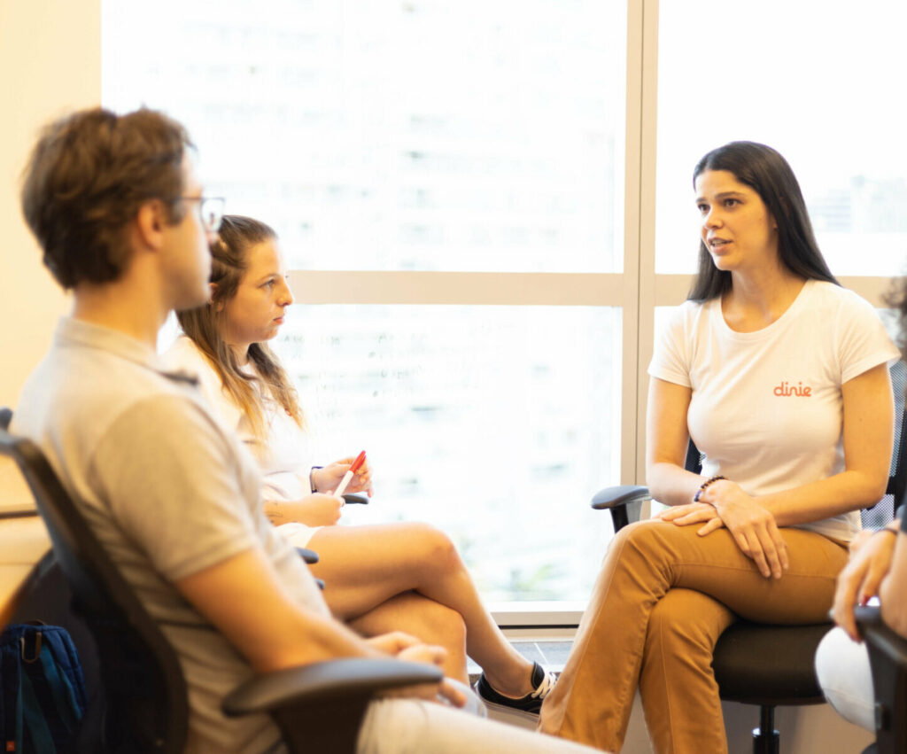 Andrea Burattini, co-founder of Dinie, meets with her team. Dinie provides affordable lending products to small businesses in Brazil by embedding financial services into digital platforms already used by businesses.