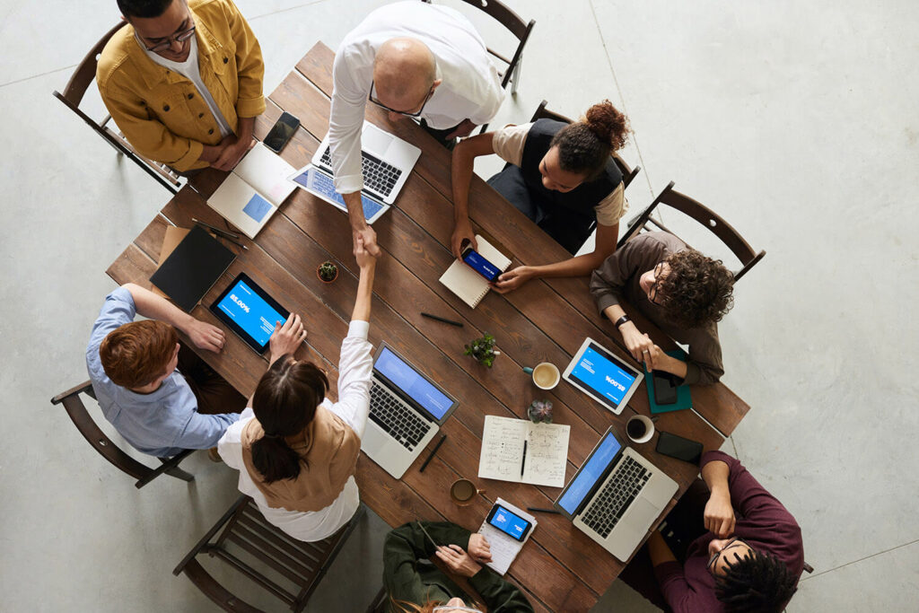 A group of individuals sitting at a table in a partnership meeting