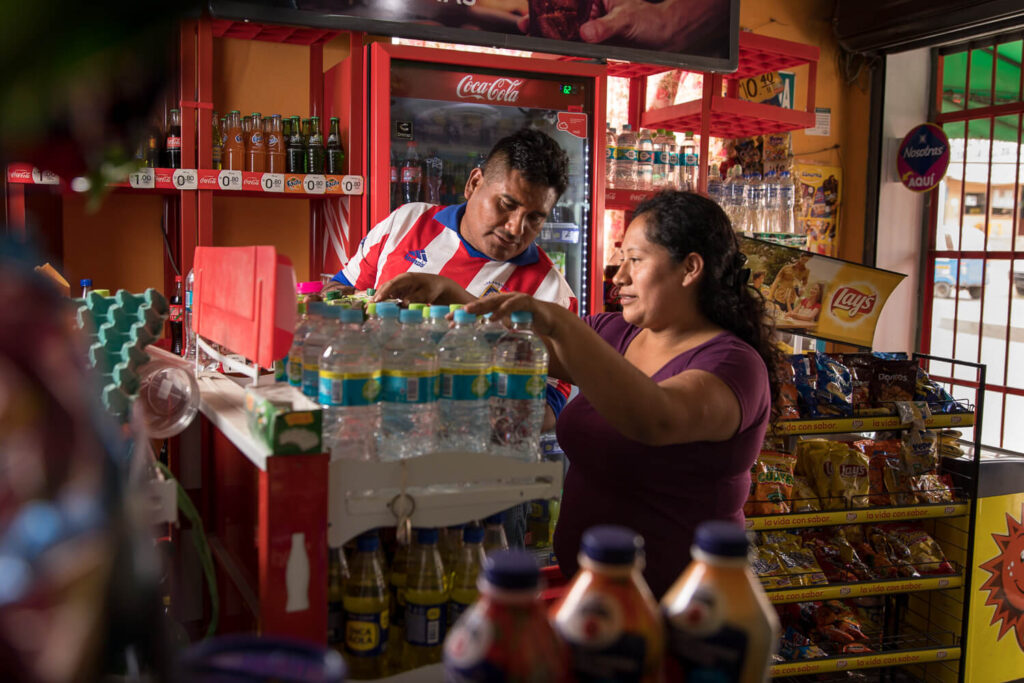 Small business owners like Yesenia León Castañeda and José Luis Calla Taipe inspecting merchandise