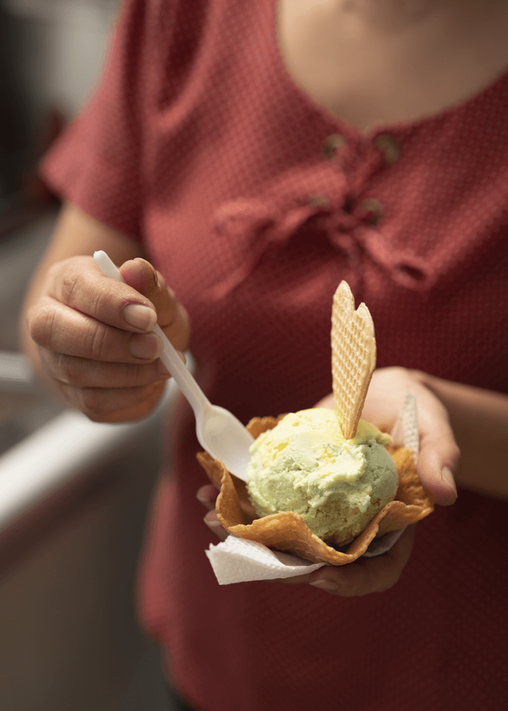 Claudia serves ice cream at her shop in Bogota