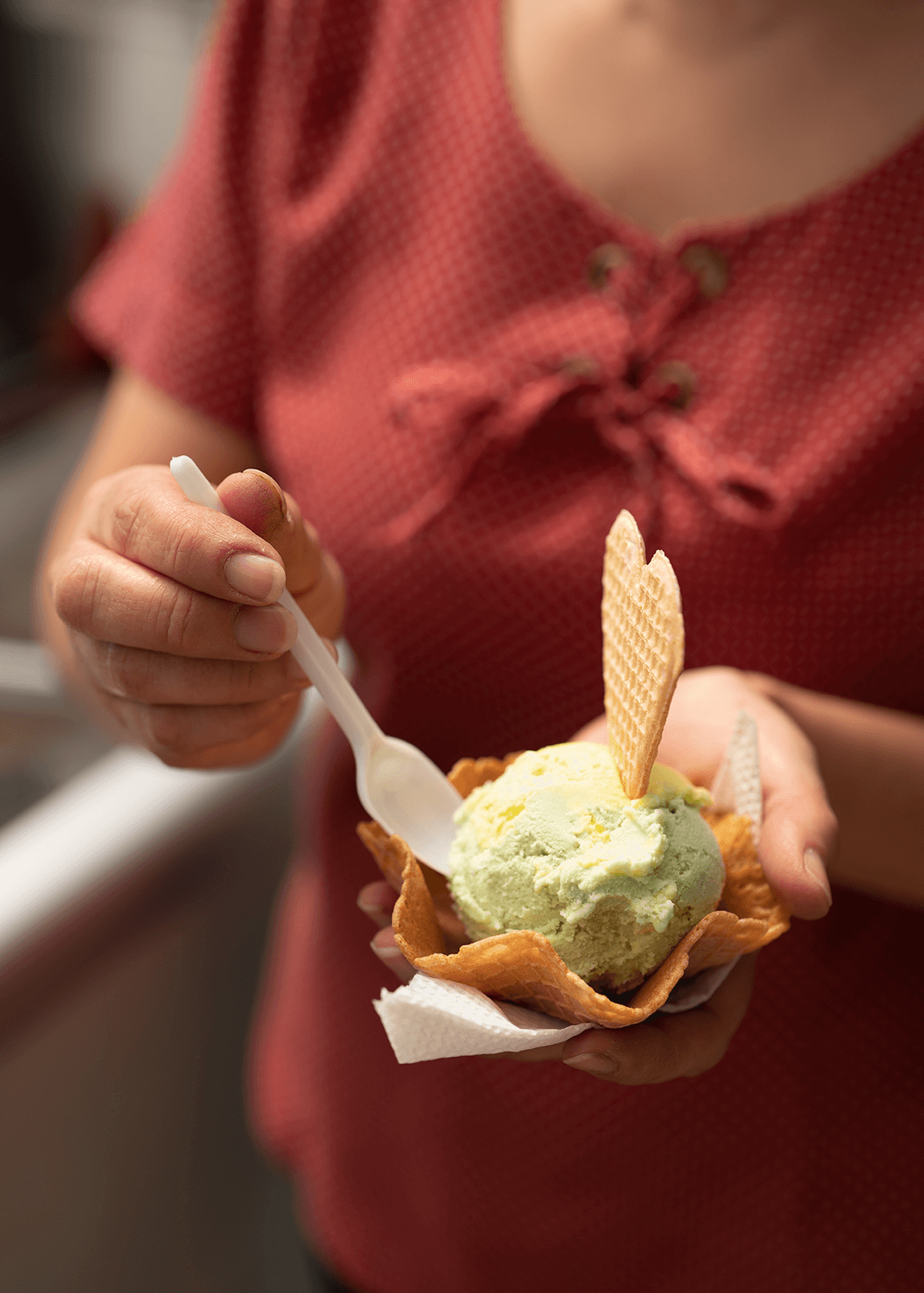 Claudia serves ice cream to a customer