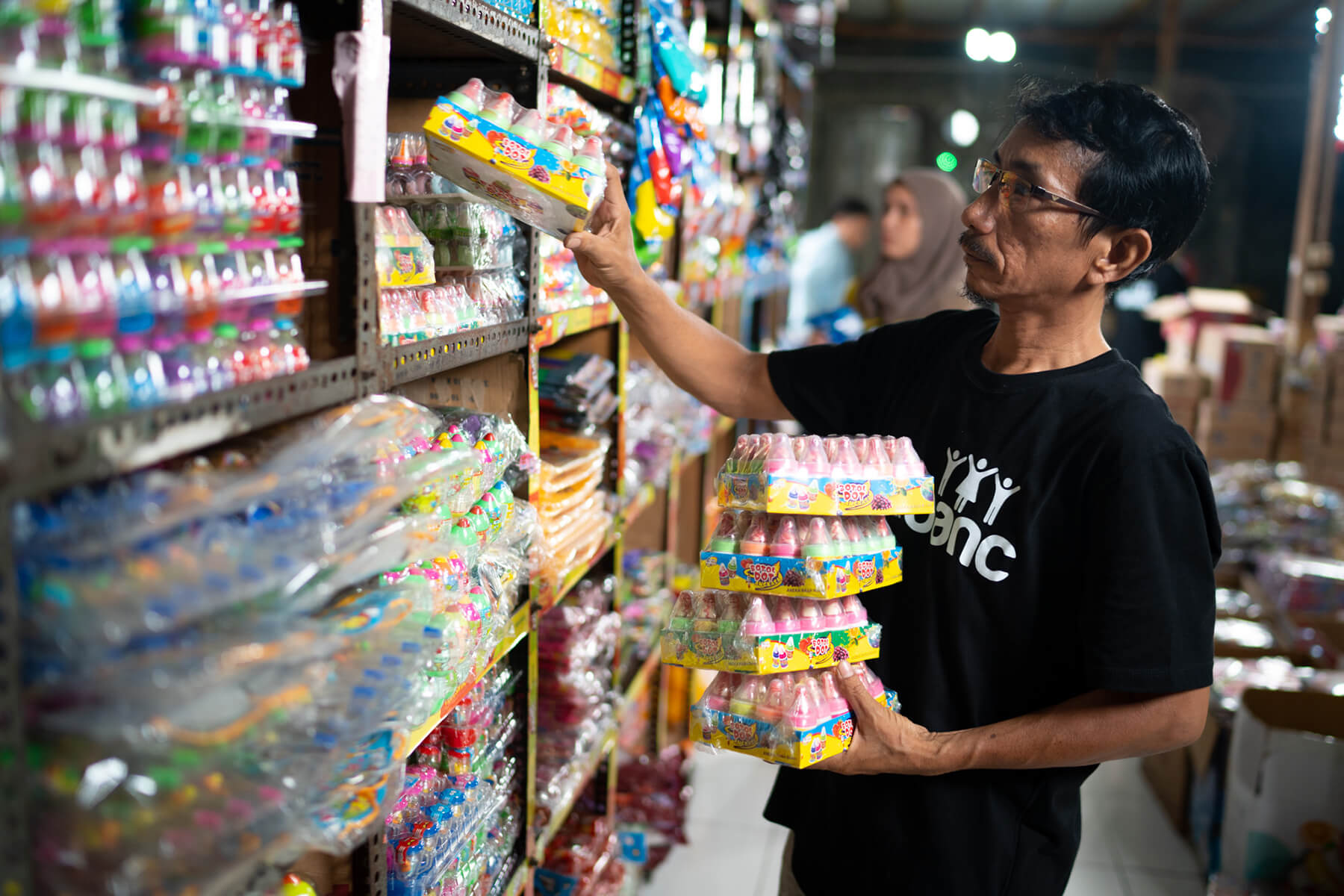 Solihin stocks his store in Indonesia