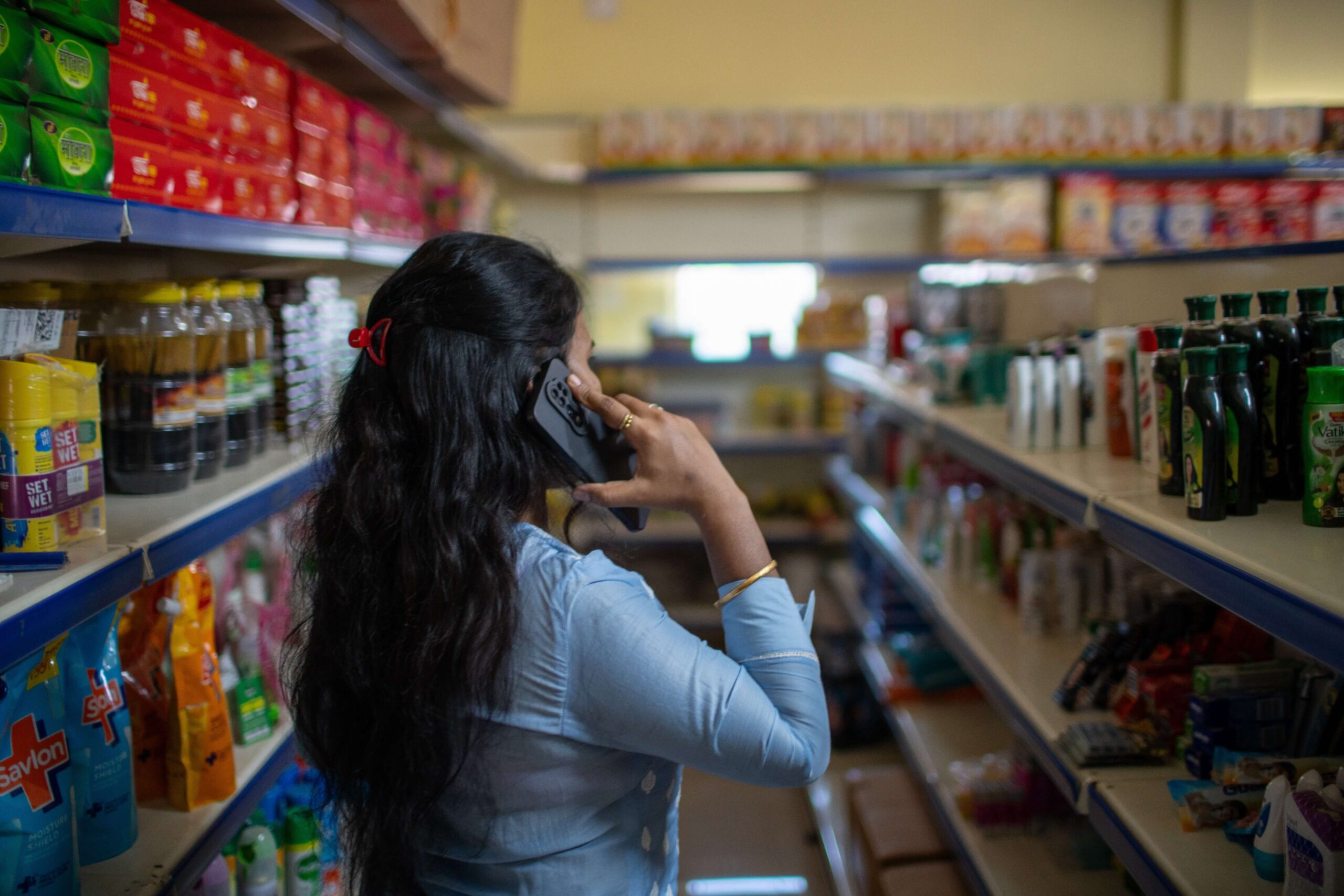 Madhusmita talks on her mobile phone in her store