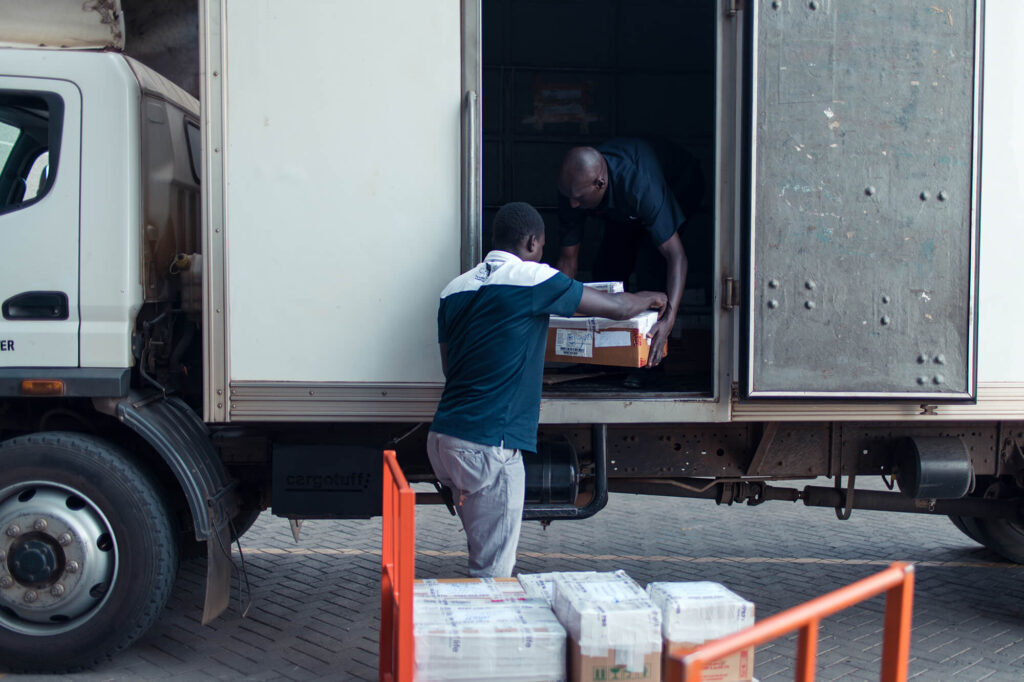 Field employees loading truck in Kenya