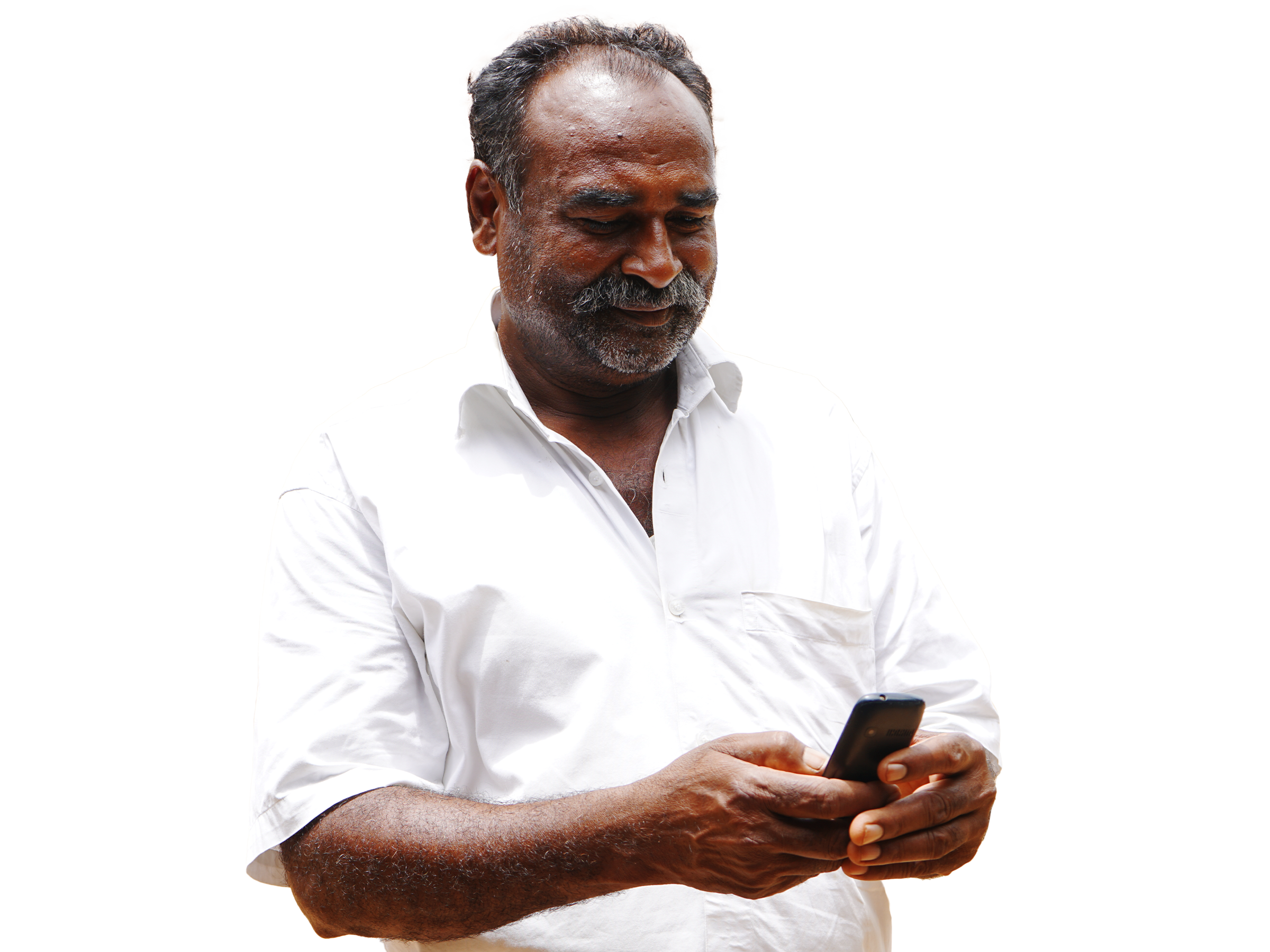 Man in market holding a mobile phone and smiling