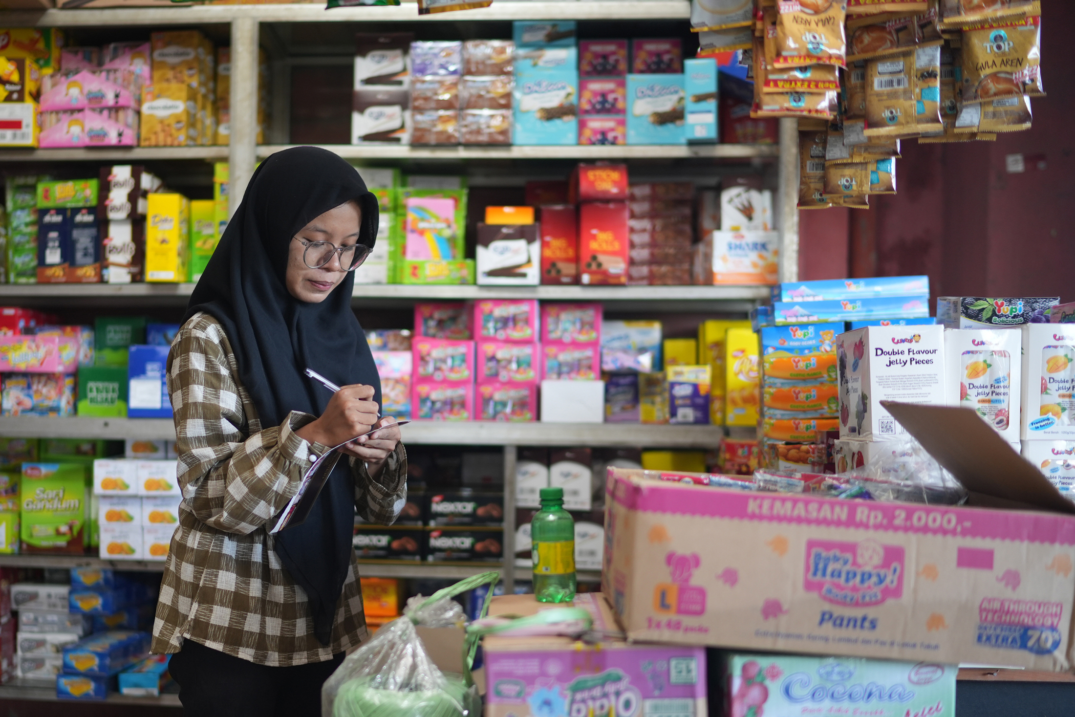 Amelia working in her store in Indonesia