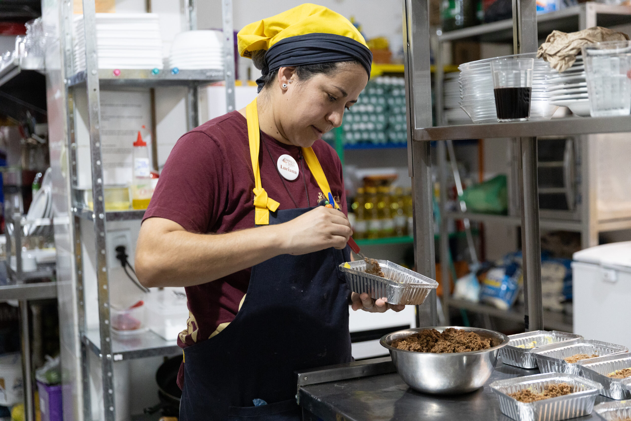 Luciana serves food in her restaurant in Brazil