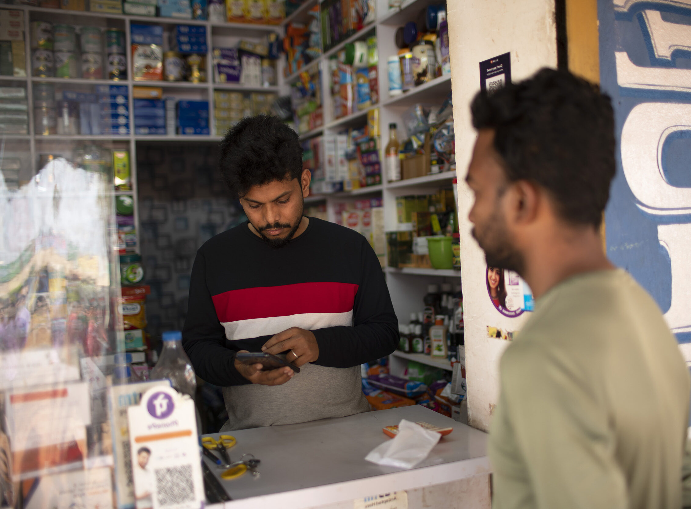 Manoranjan working on his phone in Odisha, India