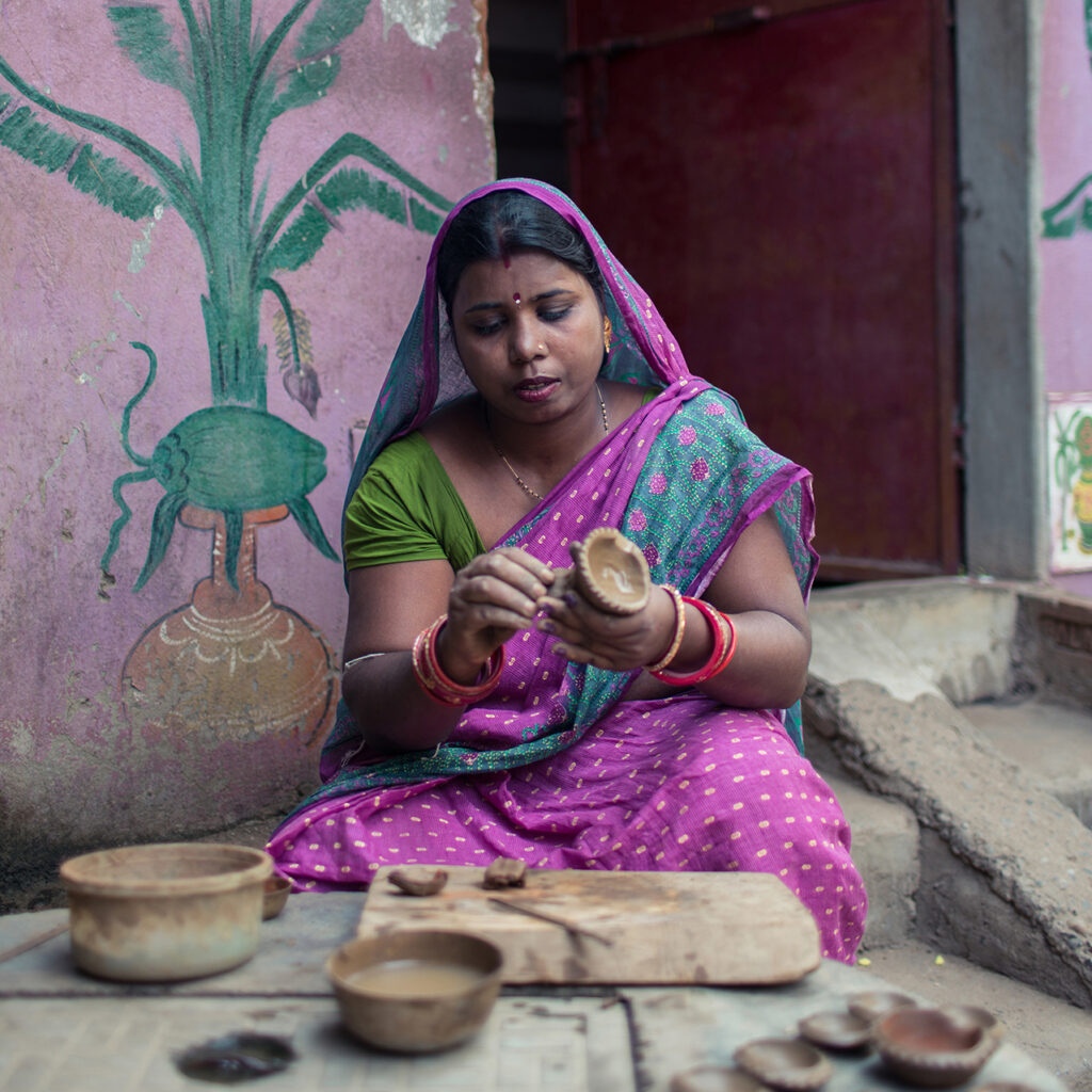 Rina sculpts a pot in Odisha, India