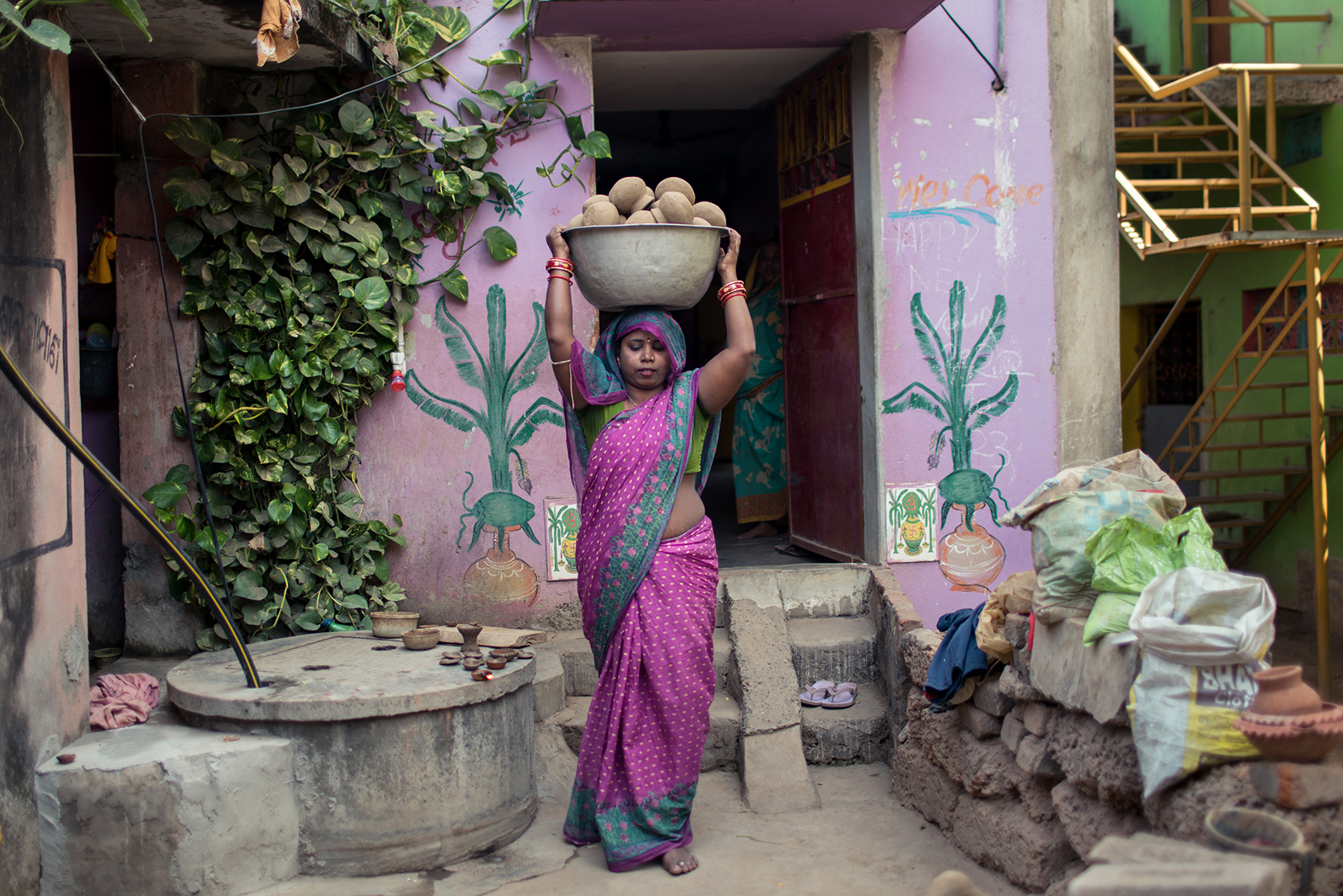 Rina carries her pottery in Odisha, India