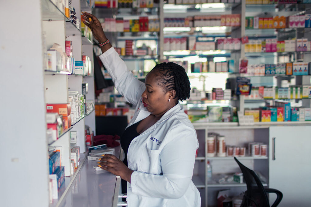 Serah stocks medicine in her pharmacy