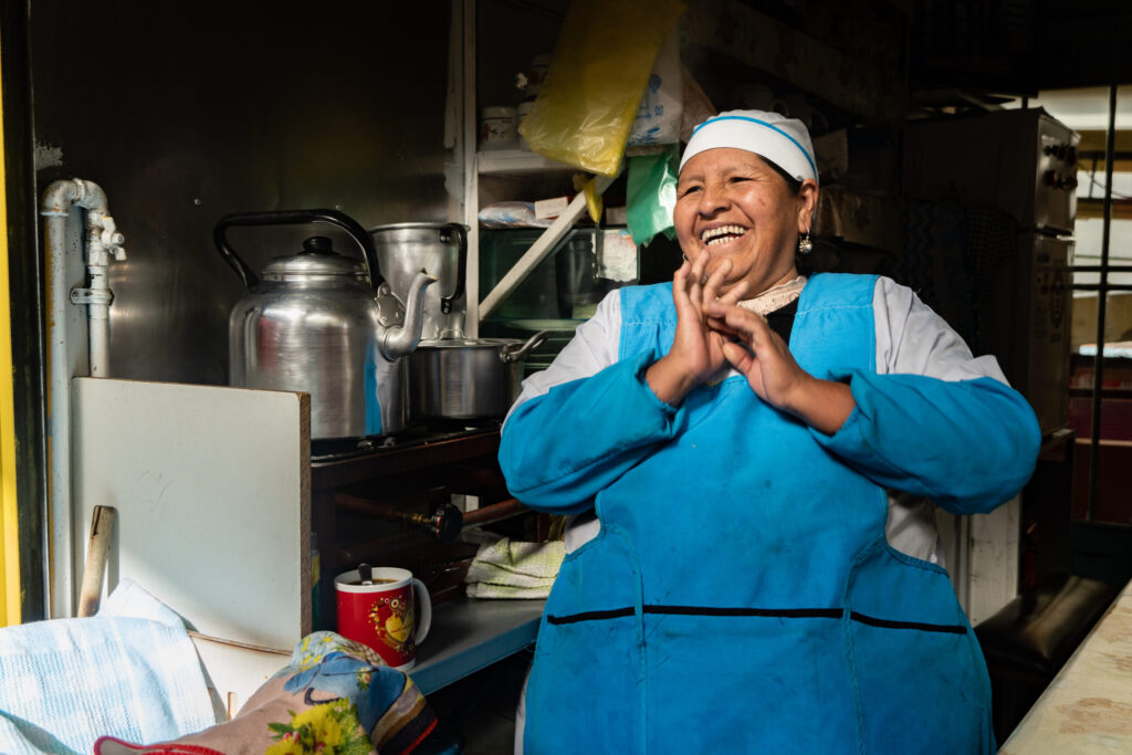 Small business owner sitting and laughing in her kitchen