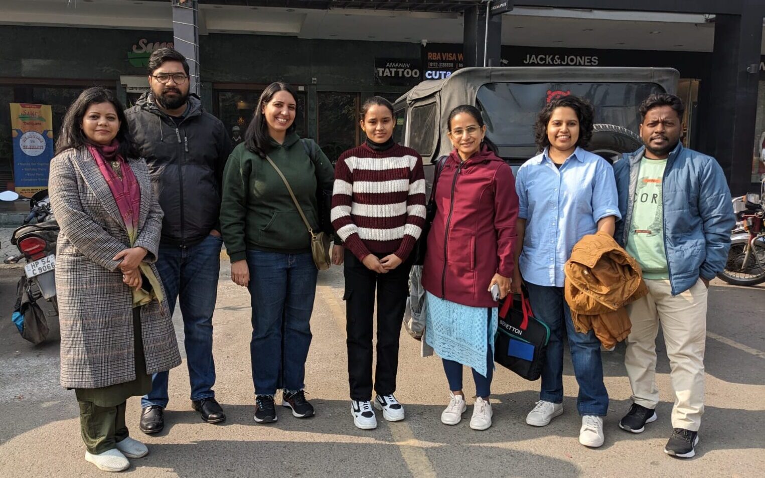 group photo in front of stores