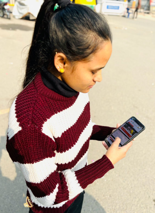 Jyoti looking at her phone and using edtech app