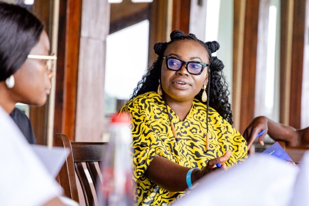 A woman talks to others in the group