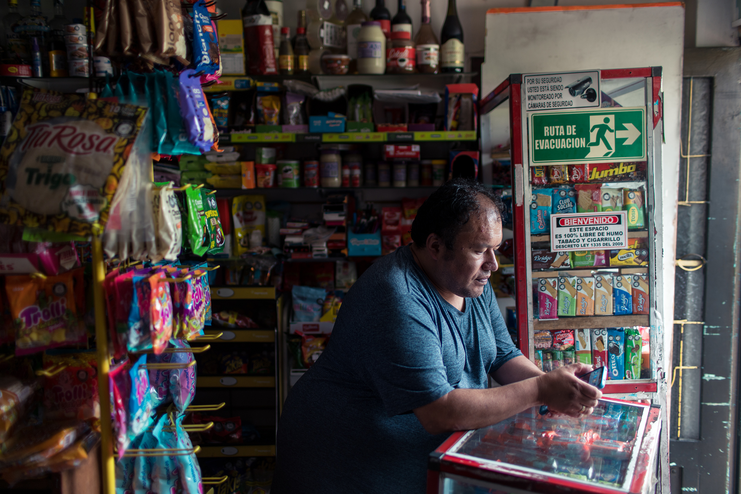Miller looks at his phone in his store