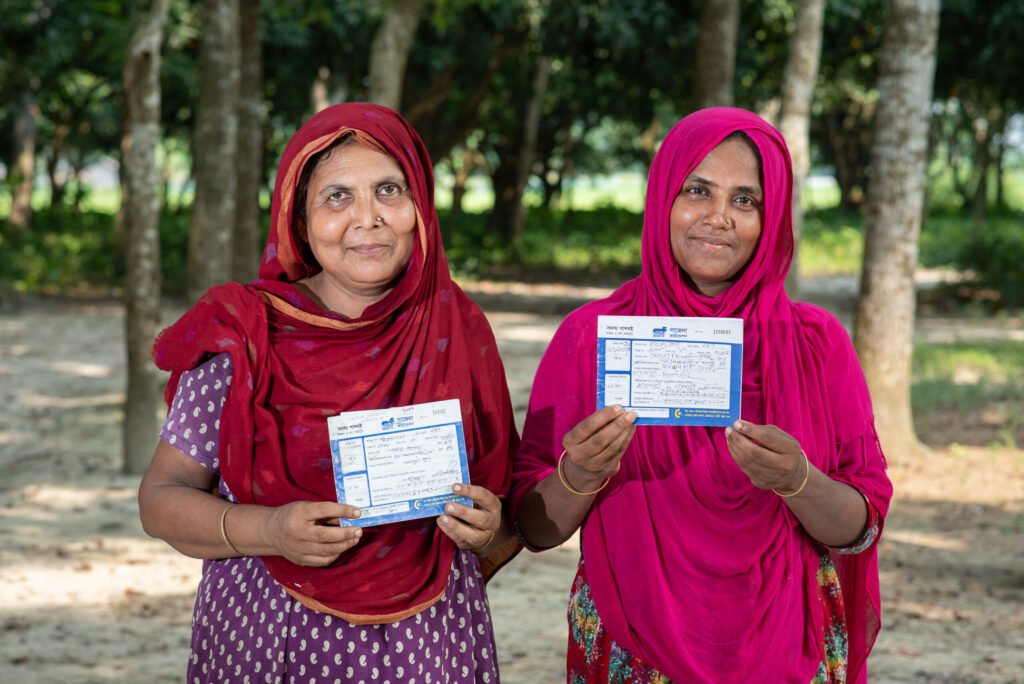 Women holding cards from Sajida