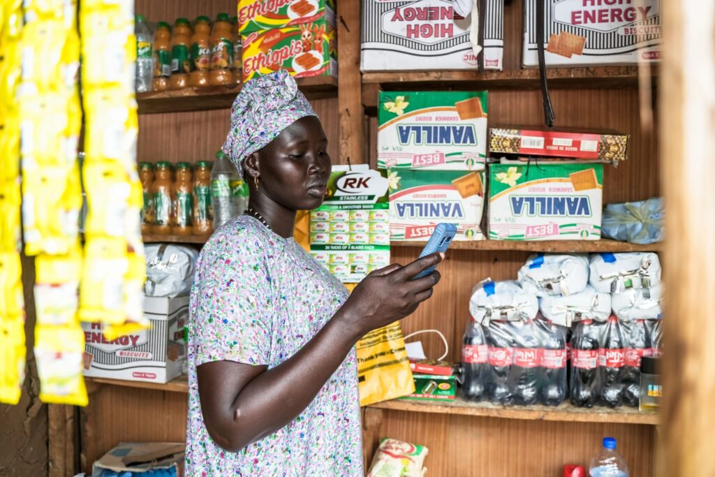 Nyabang at her store, looking at her phone