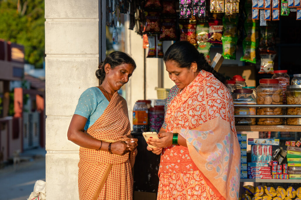 Salma, a shop owner and client of Dvara KGFS Karnataka, India, uses her phone to manage her business accounts.