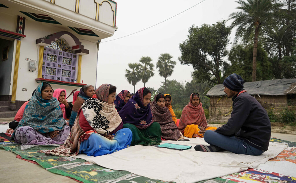 women entrepreneurs participate in group loan meeting
