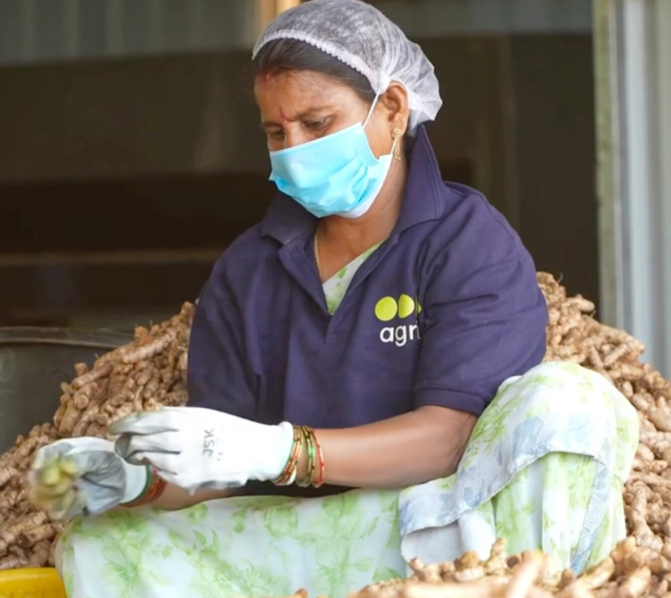woman working at tumeric processing facility in India