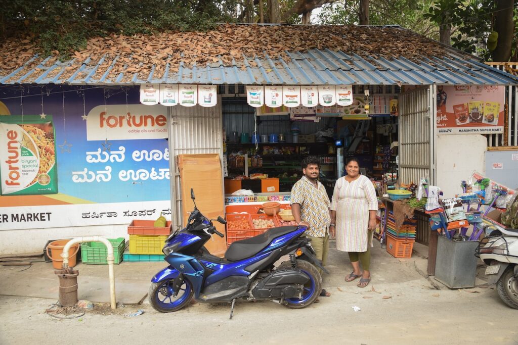 Store owner standing outside Kirana store